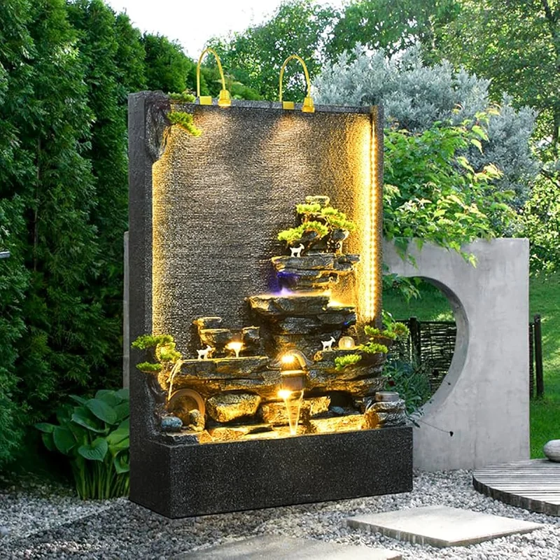 jardim moderno com fonte de água iluminada à noite