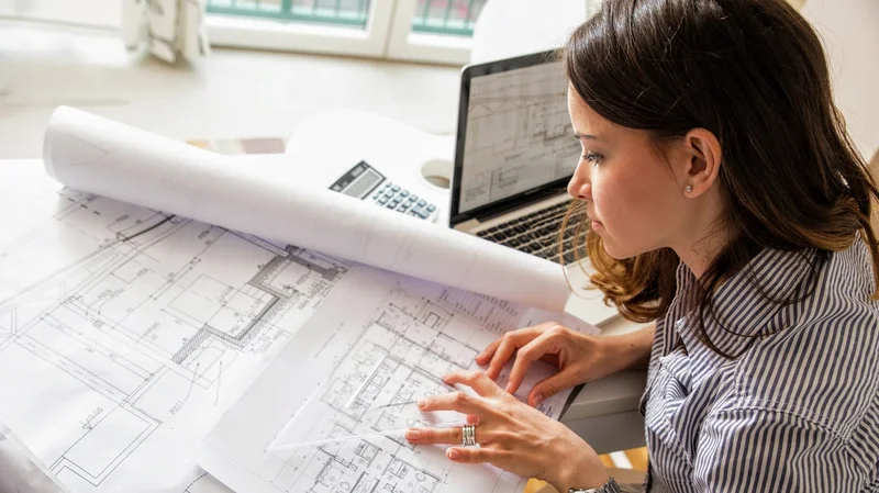 Arquiteto analisando planta baixa em escritório